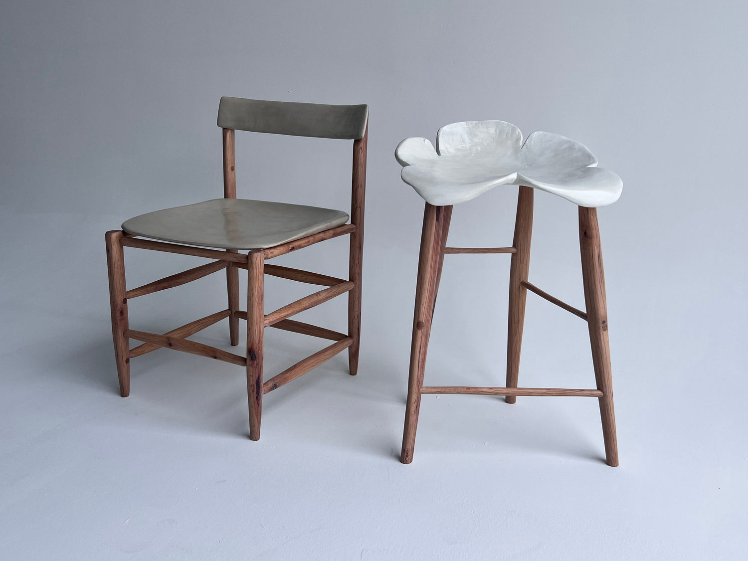 Chair and bar stool with wooden legs on a gray background